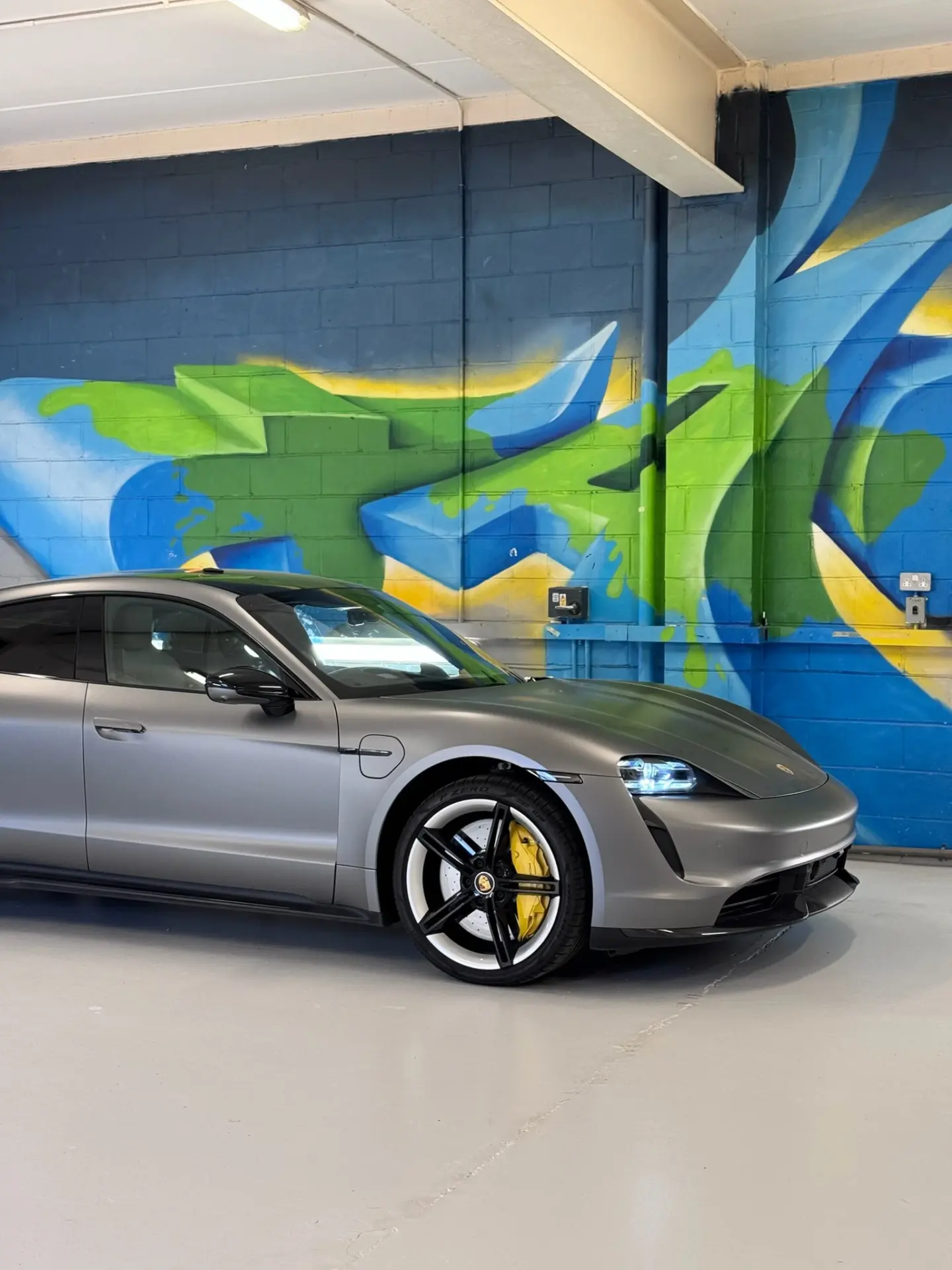 Porsche Taycan wrapped in grey vinyl by Tauro Design